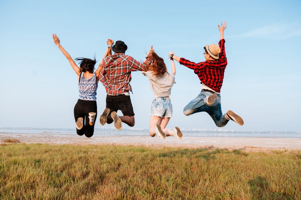 back-view-of-happy-people-jumping-in-the-air-PRPENFL-scaled.jpg